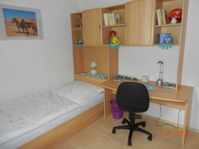 Children's playroom with bed, wardrobe and desk